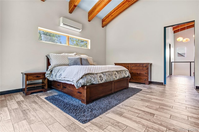 bedroom featuring lofted ceiling with beams, light wood-type flooring, and an AC wall unit