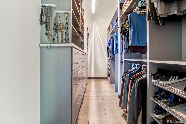 spacious closet with light tile patterned floors