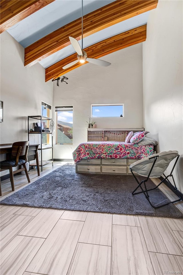 bedroom featuring beamed ceiling, wood-type flooring, high vaulted ceiling, and ceiling fan