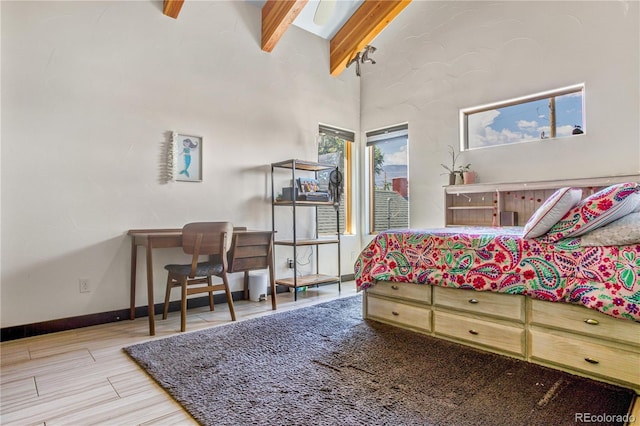 bedroom with beam ceiling, high vaulted ceiling, and hardwood / wood-style floors