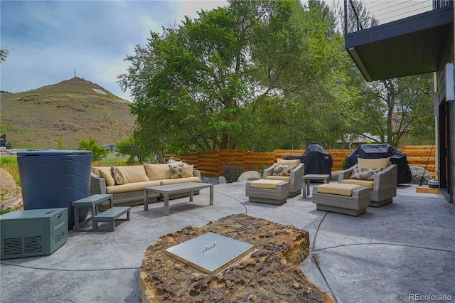 view of patio / terrace featuring an outdoor living space, a mountain view, and grilling area