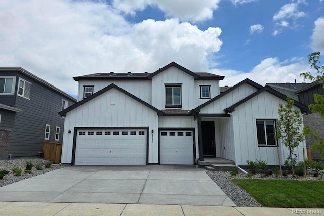 2525 Lupton Ln, Lafayette, CO 80026 - view of front facade with board and batten siding, concrete driveway, and a garage
