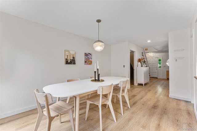 dining area with light wood finished floors and baseboards