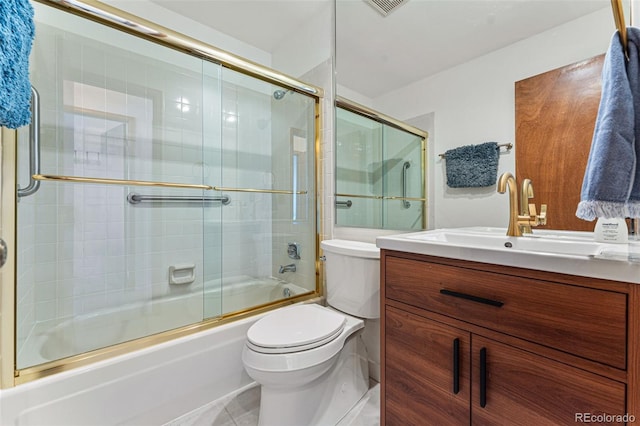 full bathroom featuring enclosed tub / shower combo, toilet, tile patterned flooring, and vanity