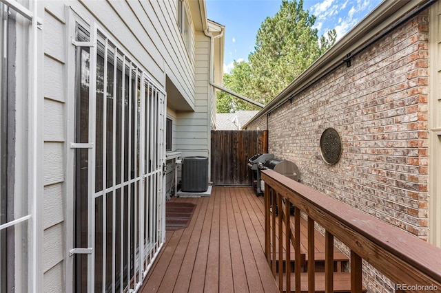 wooden terrace featuring central air condition unit