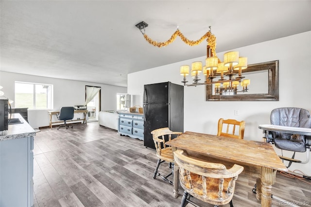 dining area featuring an inviting chandelier and wood finished floors