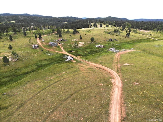 bird's eye view featuring a rural view, a mountain view, and a wooded view