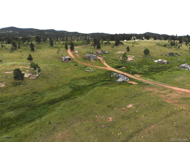 birds eye view of property with a mountain view and a rural view