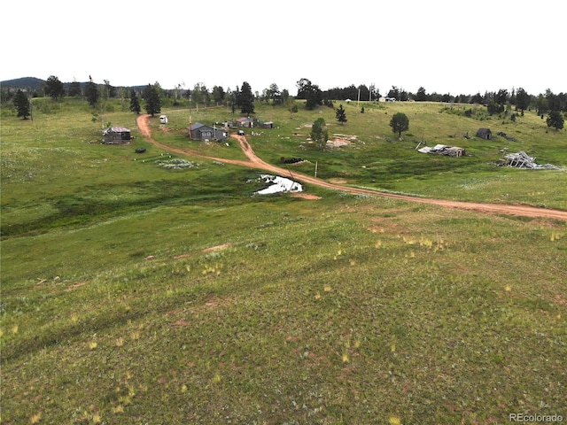 birds eye view of property with a rural view