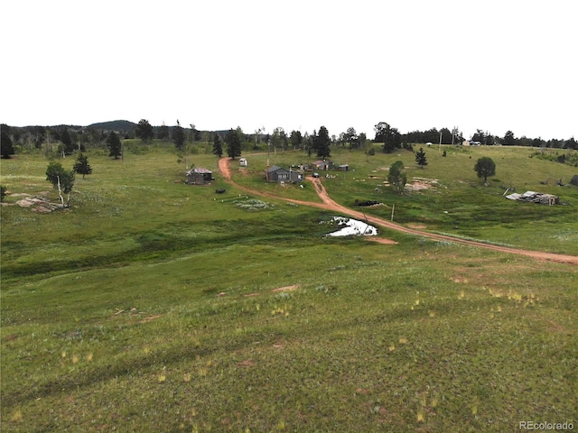 view of jungle gym featuring a lawn and a rural view