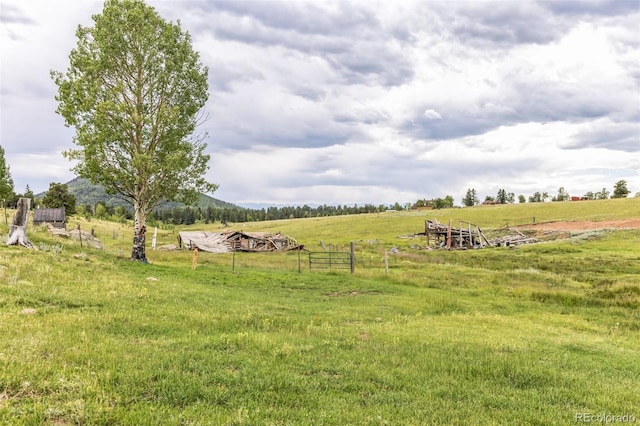 view of yard featuring a rural view and fence