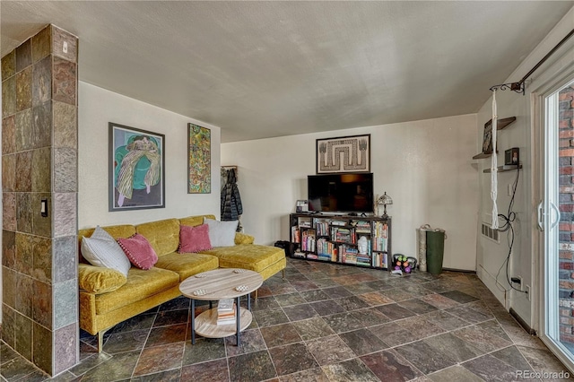 living area with stone tile floors
