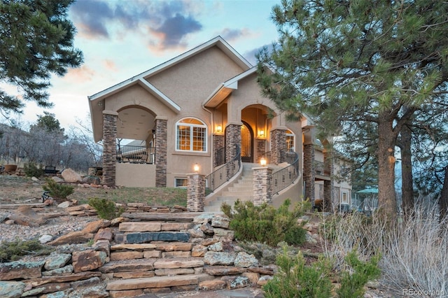 8320 Red Spring Valley Rd, Colorado Springs, CO 80919 - mediterranean / spanish house with stone siding, stucco siding, and stairs