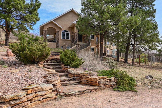 8320 Red Spring Valley Rd, Colorado Springs, CO 80919 - view of front of property with stucco siding, stairs, and stone siding