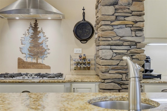 8320 Red Spring Valley Rd, Colorado Springs, CO 80919 - kitchen featuring extractor fan, a sink, light stone counters, and white cabinetry