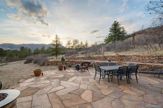 8320 Red Spring Valley Rd, Colorado Springs, CO 80919 - patio terrace at dusk with a mountain view and outdoor dining area