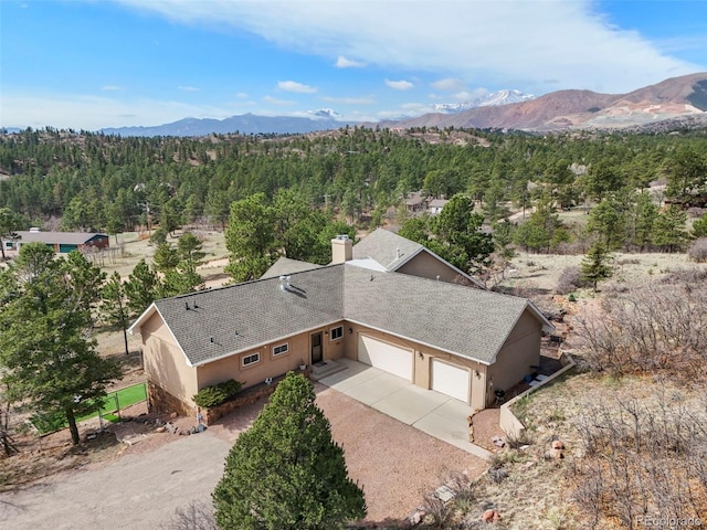 8320 Red Spring Valley Rd, Colorado Springs, CO 80919 - view of subject property featuring a mountainous background and a forest