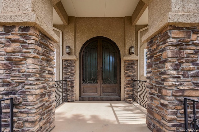 8320 Red Spring Valley Rd, Colorado Springs, CO 80919 - doorway to property with french doors, stucco siding, and stone siding