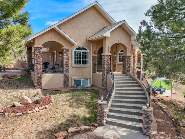 8320 Red Spring Valley Rd, Colorado Springs, CO 80919 - view of front of home with stucco siding, stairway, covered porch, and stone siding