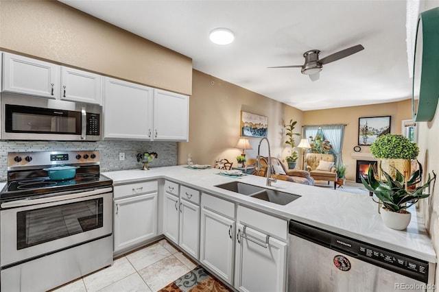 2428 W 82nd Pl Unit 1D, Westminster, CO 80031 - kitchen featuring stainless steel appliances, decorative backsplash, ceiling fan, light countertops, and white cabinets