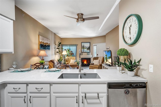 2428 W 82nd Pl Unit 1D, Westminster, CO 80031 - kitchen featuring dishwasher, open floor plan, ceiling fan, a lit fireplace, and a peninsula