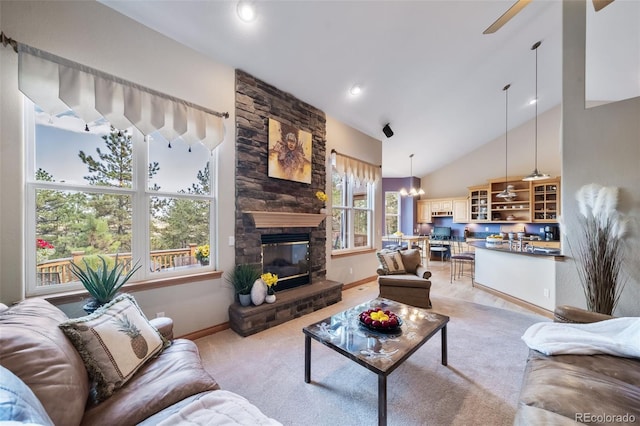 carpeted living room featuring high vaulted ceiling, a wealth of natural light, and a stone fireplace