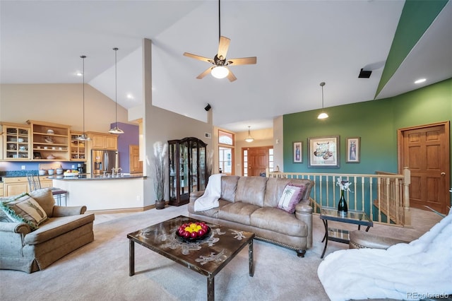 living room with light carpet, high vaulted ceiling, and ceiling fan