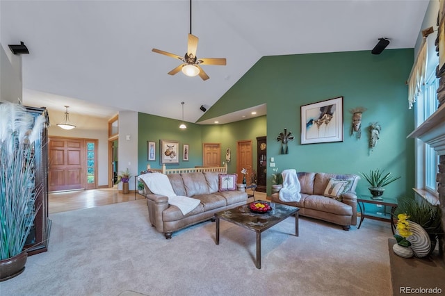 carpeted living room with high vaulted ceiling and ceiling fan