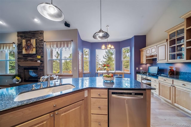 kitchen with sink, dishwasher, light hardwood / wood-style floors, and decorative light fixtures