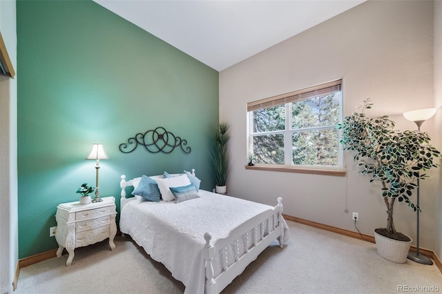 bedroom featuring carpet floors and vaulted ceiling