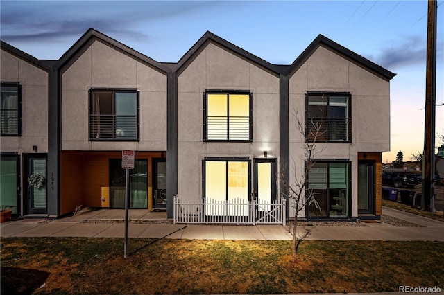 rear view of property featuring stucco siding and a patio