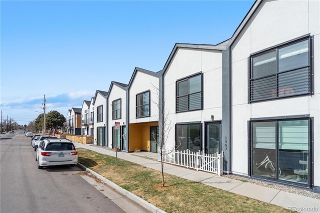 view of street featuring a residential view, curbs, and sidewalks