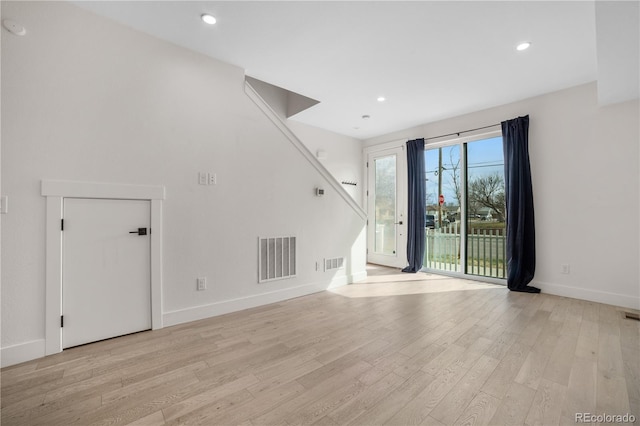 unfurnished living room with visible vents, recessed lighting, baseboards, and light wood-style floors