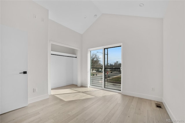 unfurnished bedroom with visible vents, baseboards, light wood-style floors, and access to outside