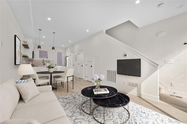 1907 W Elk Pl, Denver, CO 80211 - living room with light wood-type flooring, recessed lighting, and stairs