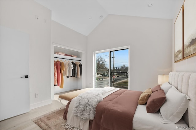1907 W Elk Pl, Denver, CO 80211 - bedroom with light wood-style flooring, high vaulted ceiling, and access to exterior