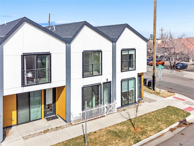1907 W Elk Pl, Denver, CO 80211 - view of front of house with stucco siding, a balcony, and a shingled roof