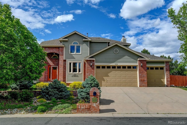 8286 W 108th Pl, Westminster, CO 80021 - traditional home with an attached garage, brick siding, driveway, and a chimney