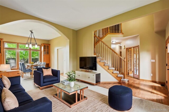 8286 W 108th Pl, Westminster, CO 80021 - living area with arched walkways, wood finished floors, and stairway