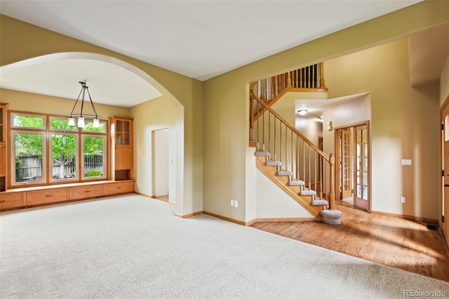 8286 W 108th Pl, Westminster, CO 80021 - carpeted entryway featuring arched walkways, stairs, and french doors