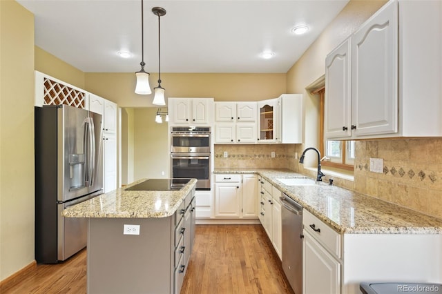 8286 W 108th Pl, Westminster, CO 80021 - kitchen featuring appliances with stainless steel finishes, light wood-type flooring, light stone countertops, and white cabinets