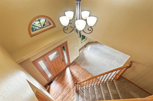 8286 W 108th Pl, Westminster, CO 80021 - entrance foyer featuring a chandelier, stairs, a high ceiling, and wood finished floors