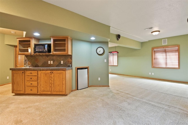 8286 W 108th Pl, Westminster, CO 80021 - kitchen with black microwave, light carpet, open shelves, decorative backsplash, and healthy amount of natural light