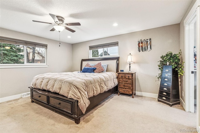 bedroom featuring light colored carpet, multiple windows, and baseboards