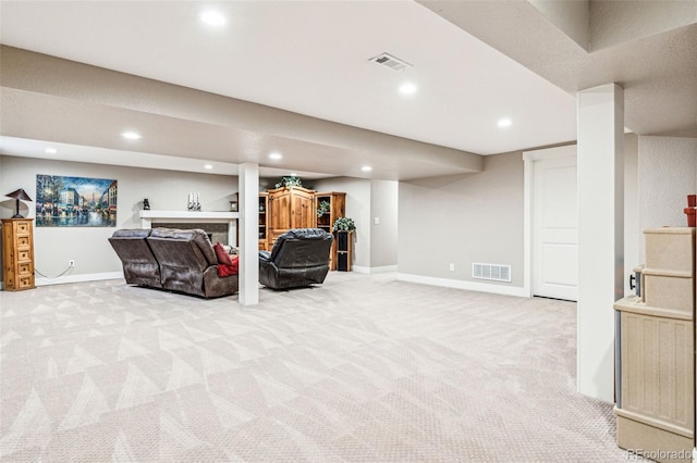 living area with recessed lighting, visible vents, and light colored carpet