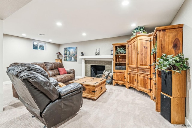 living area featuring visible vents, recessed lighting, and light colored carpet
