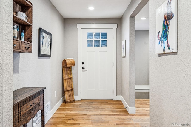 14290 W 54th Ave, Arvada, CO 80002 - foyer featuring light wood finished floors, baseboards, a textured wall, and recessed lighting