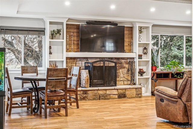 14290 W 54th Ave, Arvada, CO 80002 - living room featuring wood finished floors, a stone fireplace, and recessed lighting