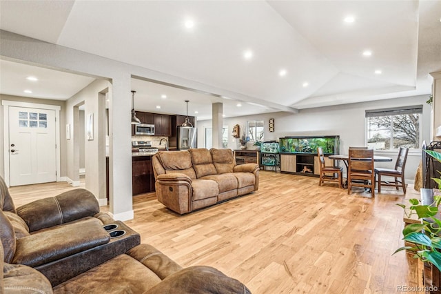 14290 W 54th Ave, Arvada, CO 80002 - living area featuring light wood-type flooring, recessed lighting, lofted ceiling, and baseboards