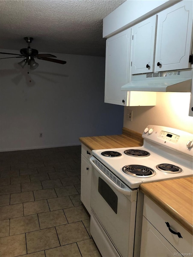 kitchen with dark tile floors, white cabinetry, electric stove, ceiling fan, and a textured ceiling